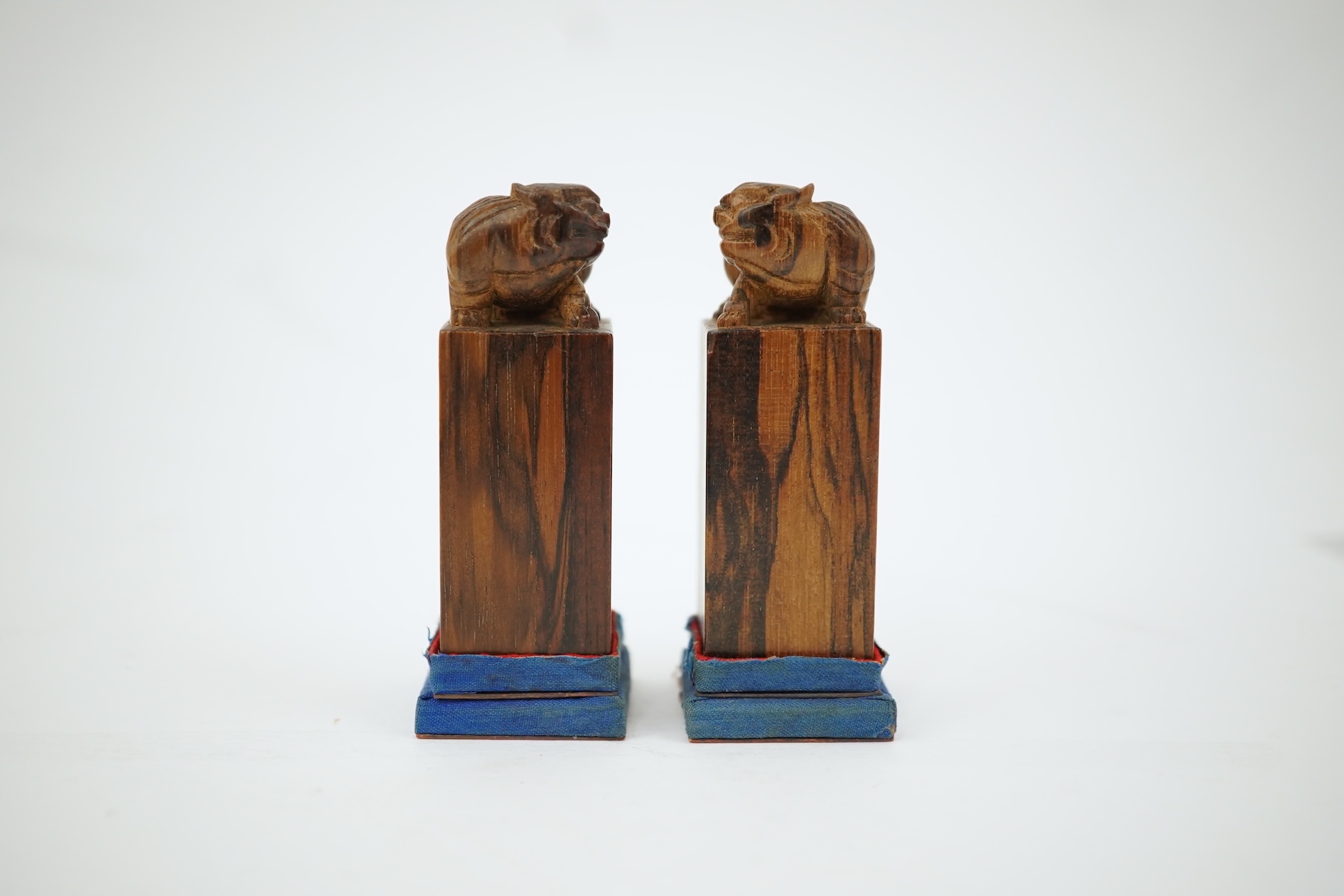 A cased pair of Chinese hardwood ‘lion-dog’ seals, early 20th century